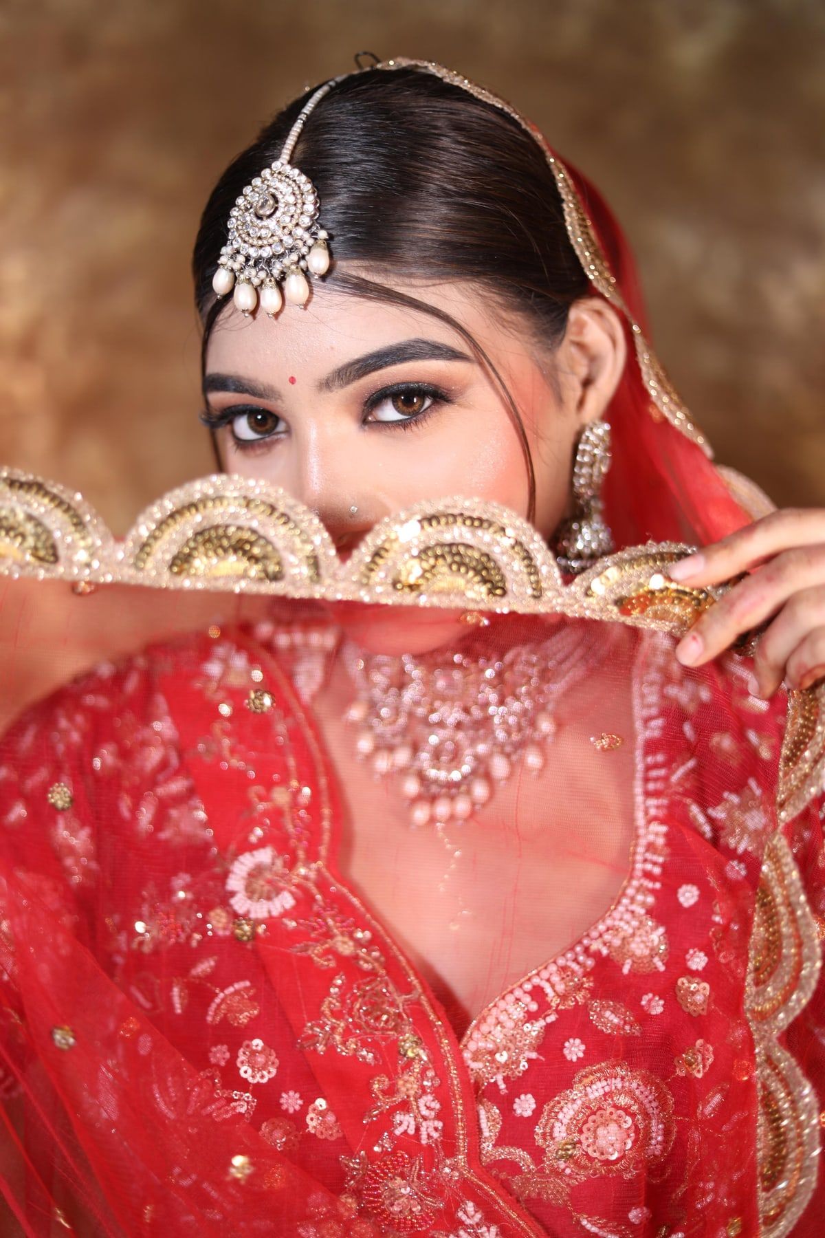 Bridal eye makeup framed by embroidered dupatta